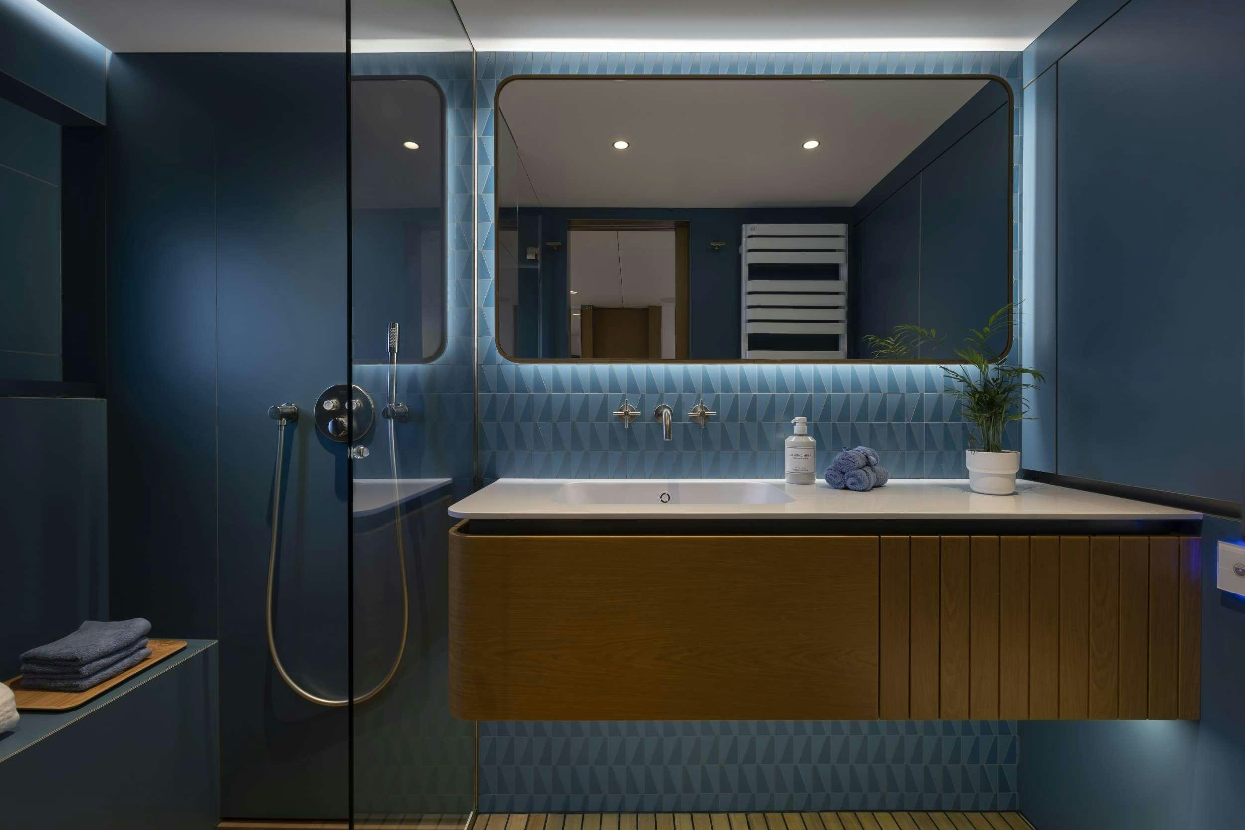 a bathroom with a large mirror aboard PRONTO Yacht for Charter