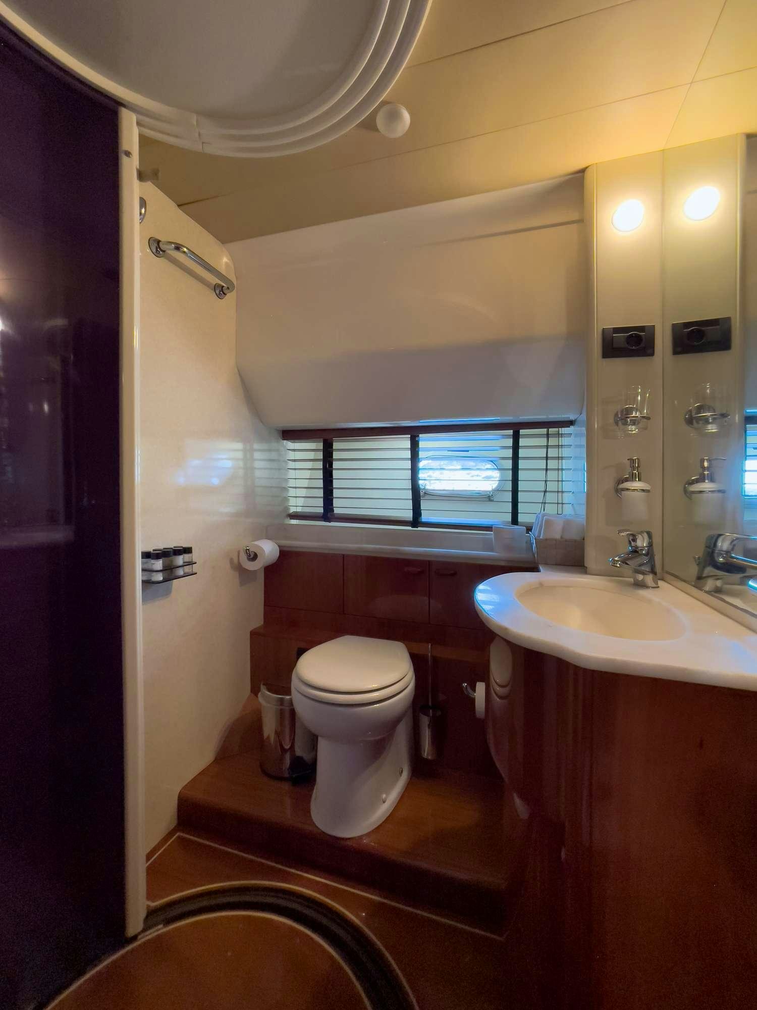 a bathroom with a toilet and sink aboard MY WAY Yacht for Charter