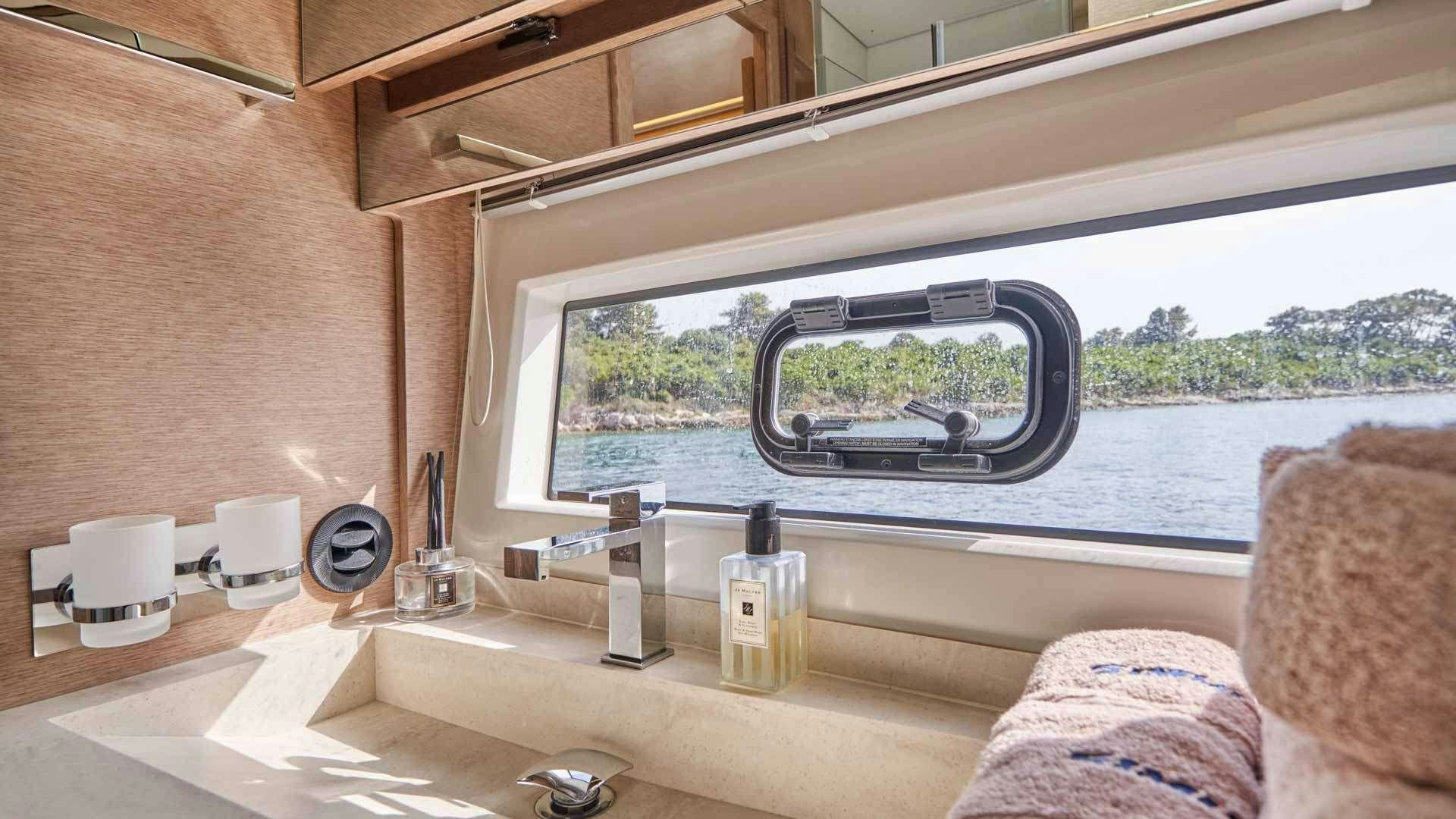 a bathroom with a large window aboard SIMULL Yacht for Charter