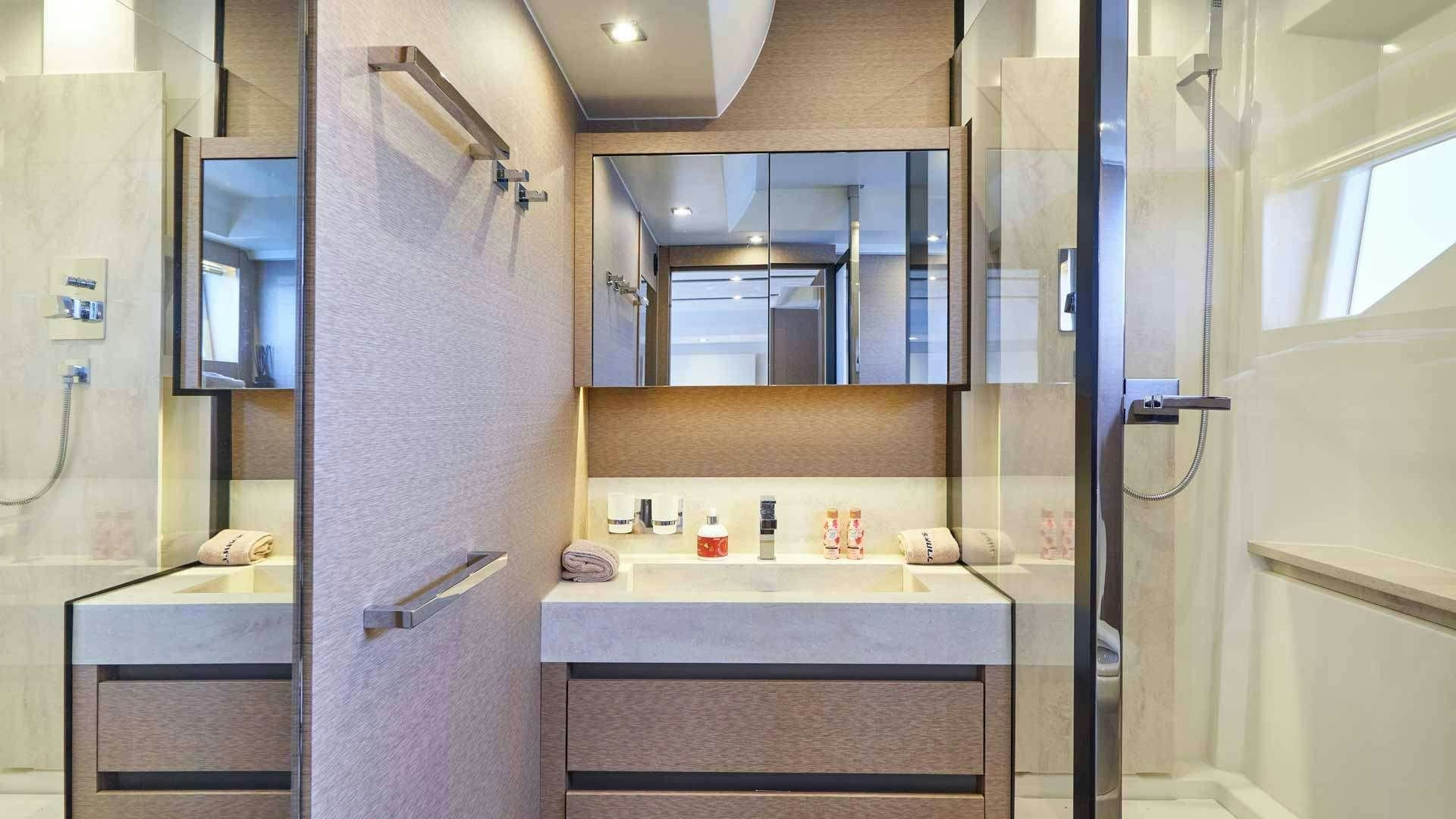 a bathroom with a sink and mirror aboard SIMULL Yacht for Charter