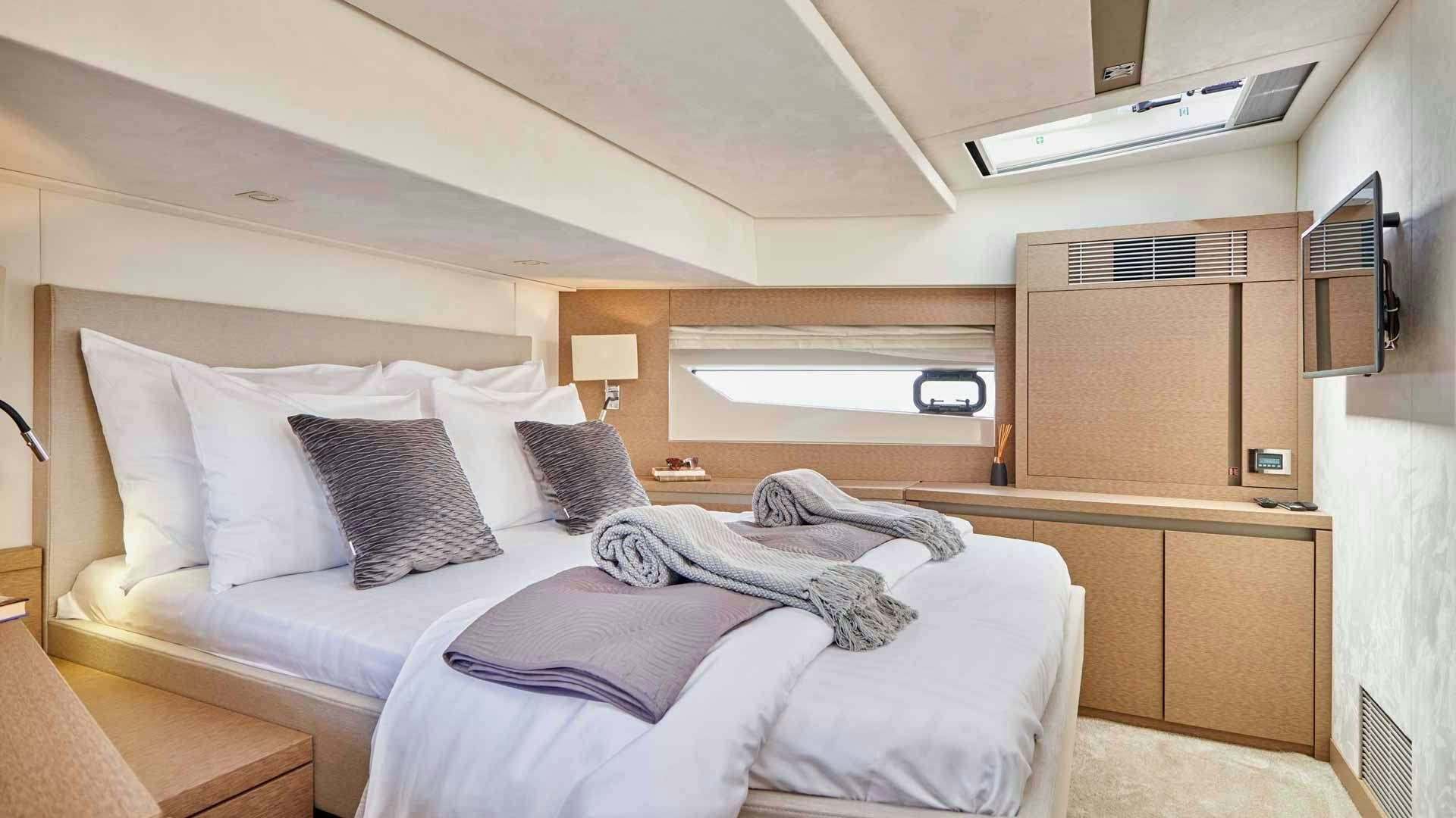 a person lying on a bed aboard SIMULL Yacht for Charter