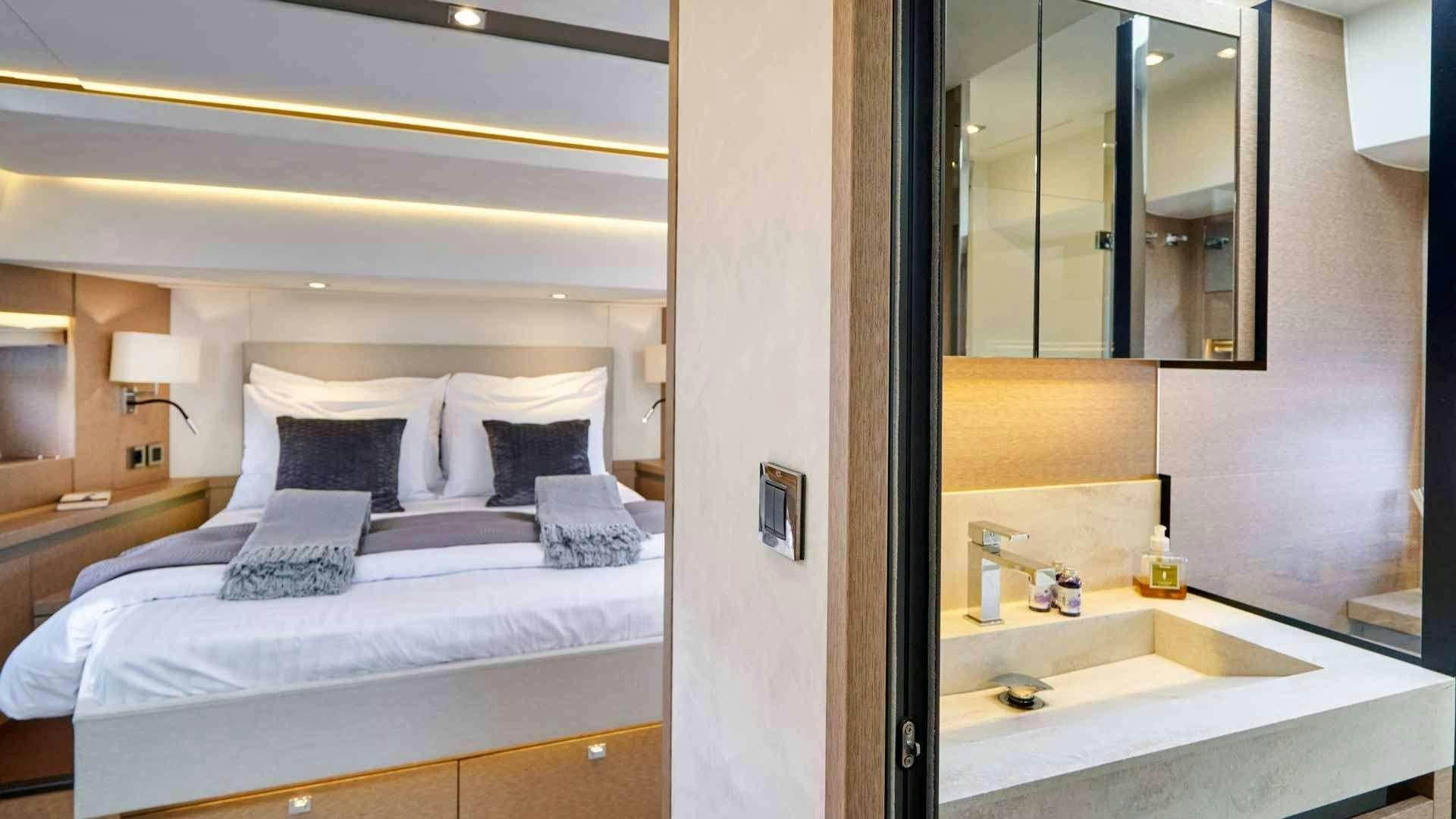 a hotel room with a bed and a sink aboard SIMULL Yacht for Charter