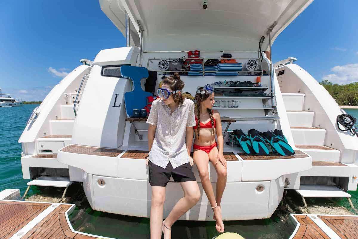 a man and woman standing on a boat aboard LAGO PARADISE Yacht for Charter