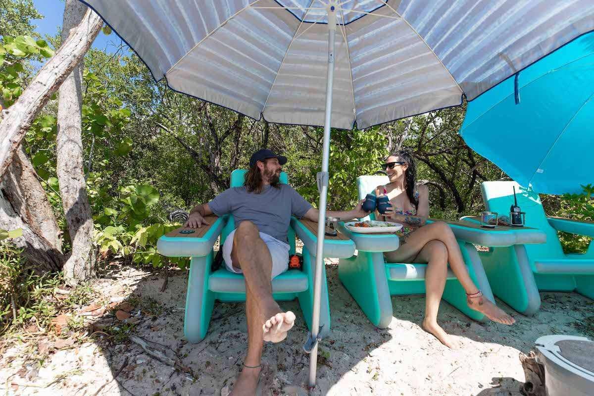 two women sitting under an umbrella aboard LAGO PARADISE Yacht for Charter