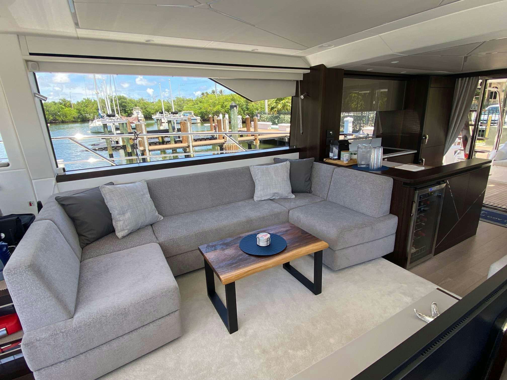 a living room with a couch and a coffee table aboard LAGO PARADISE Yacht for Charter