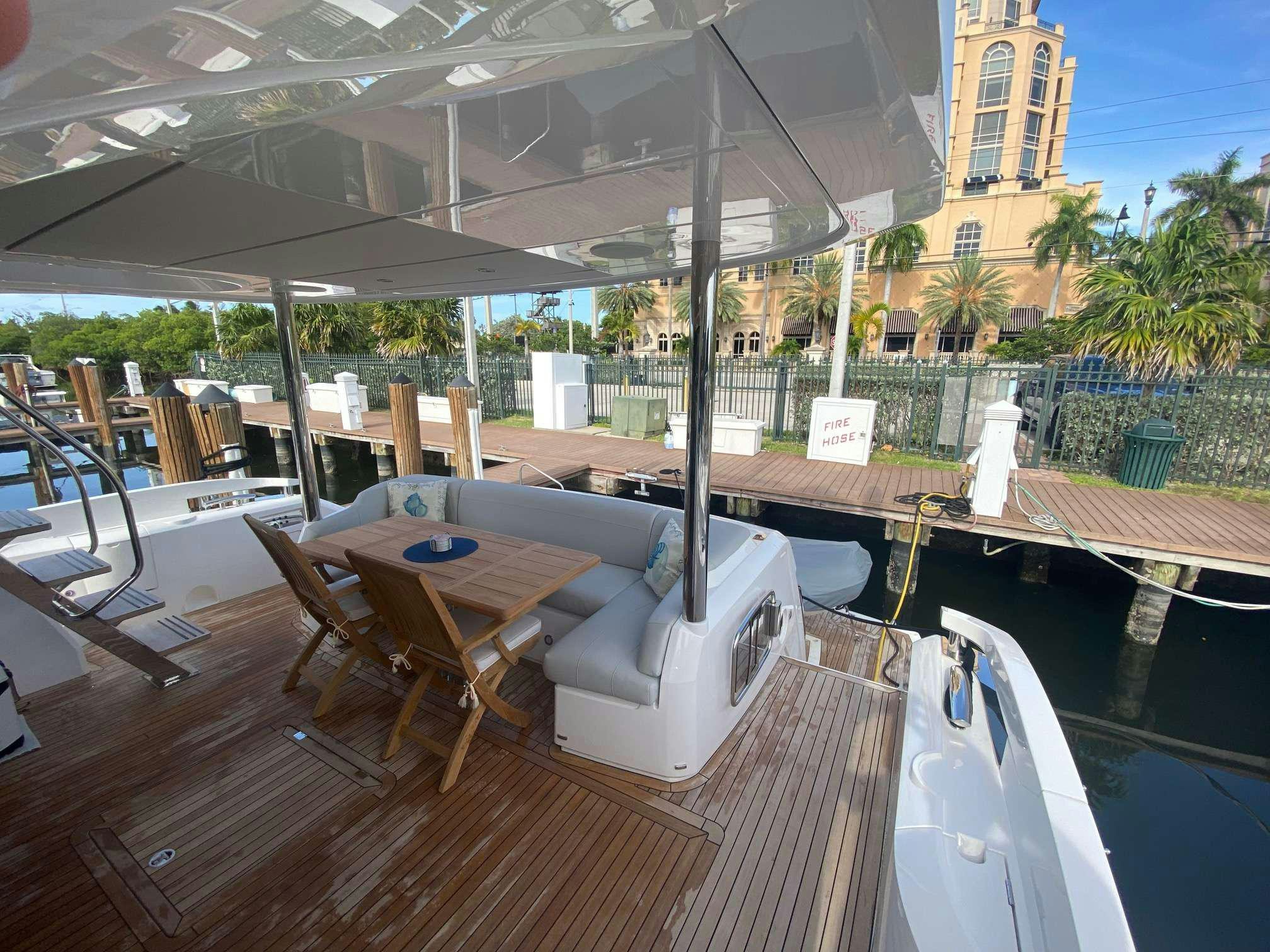 a deck with a pool and lounge chairs aboard LAGO PARADISE Yacht for Charter
