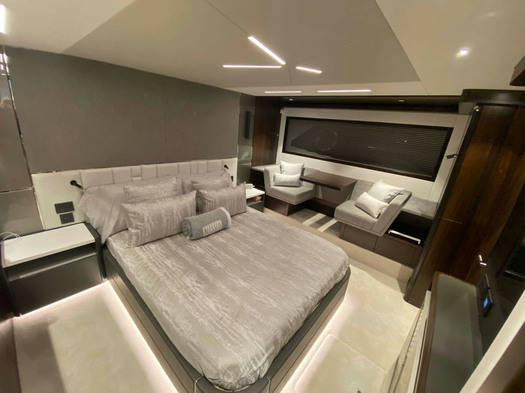 a large room with a bed and a tv aboard LAGO PARADISE Yacht for Charter