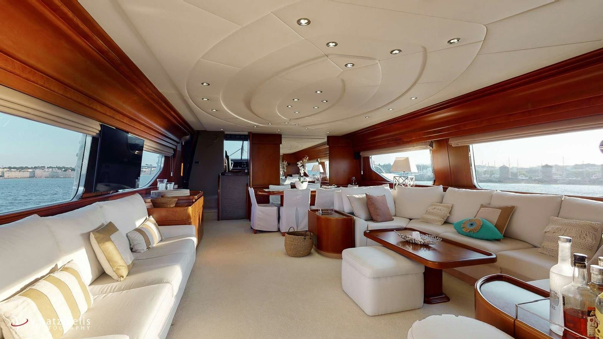 a large room with a bed and a table aboard NATASSA Yacht for Charter