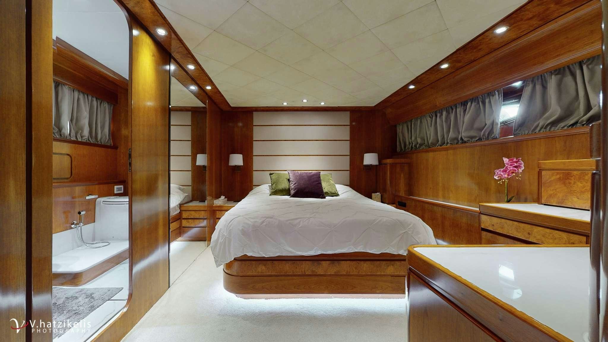 a room with a bed and a mirror aboard NATASSA Yacht for Charter