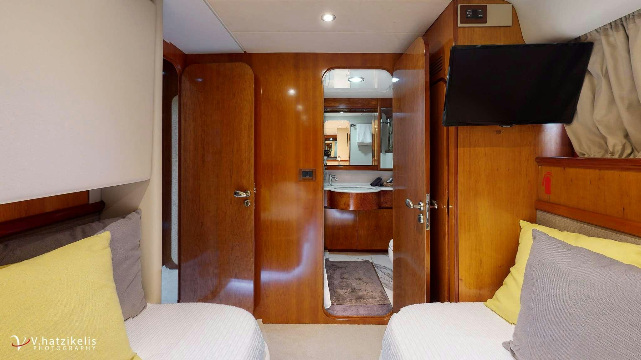 a room with a bed and a closet aboard NATASSA Yacht for Charter