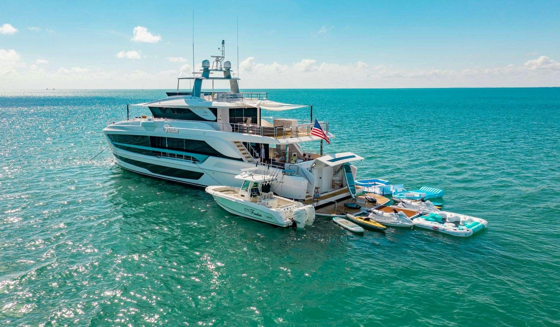 a boat and a small boat in the water aboard FREEDOM Yacht for Charter