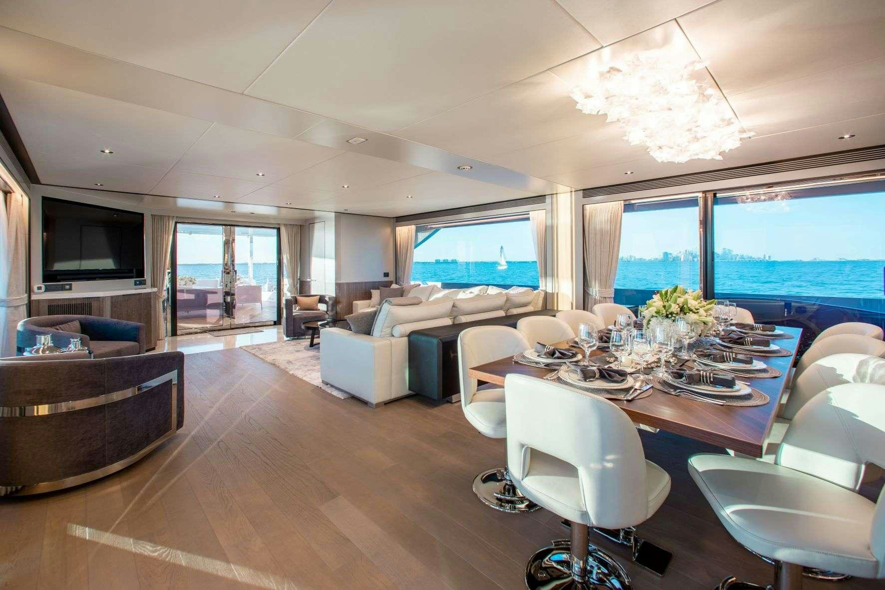a large room with a table and chairs aboard FREEDOM Yacht for Charter