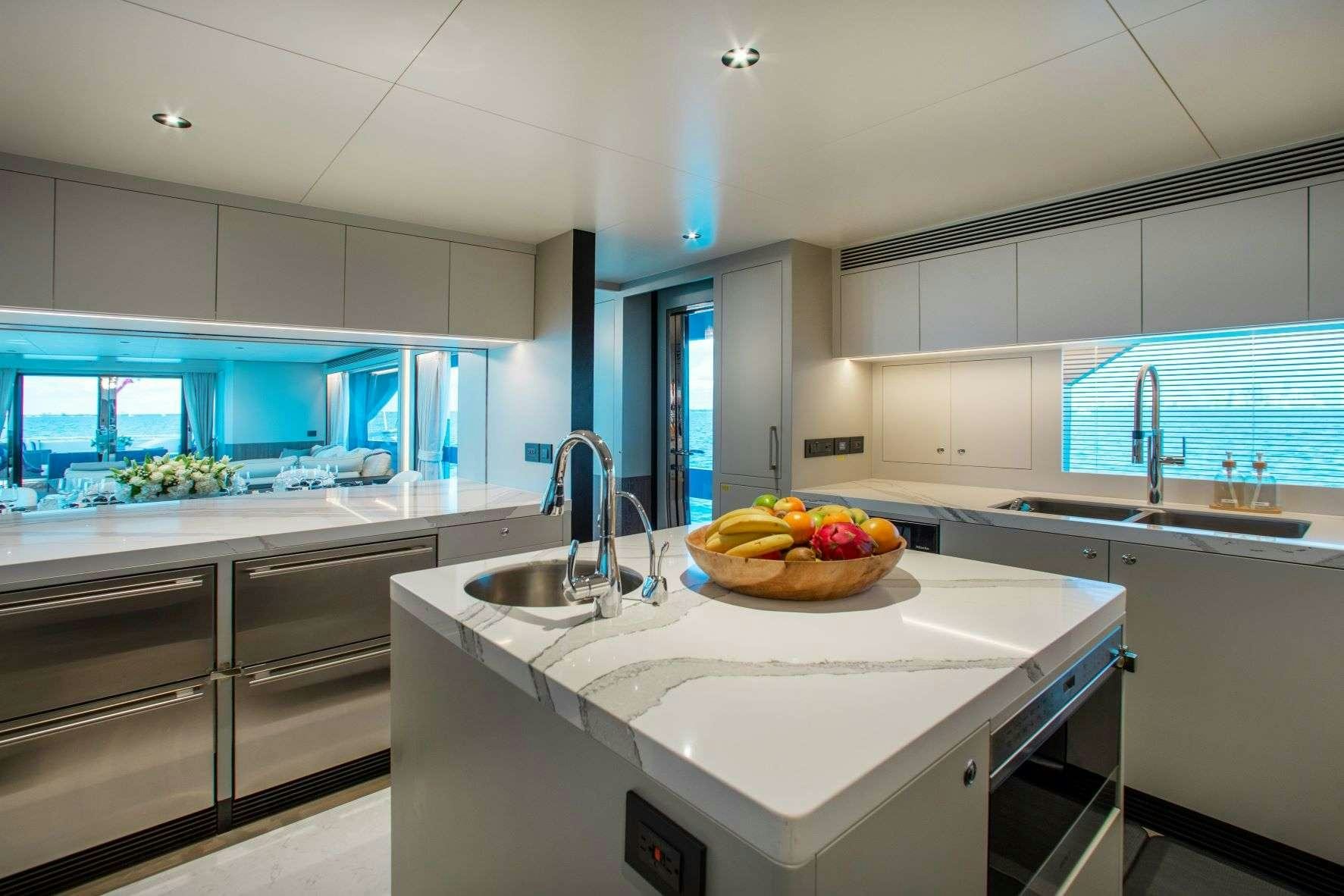a kitchen with white cabinets aboard FREEDOM Yacht for Charter