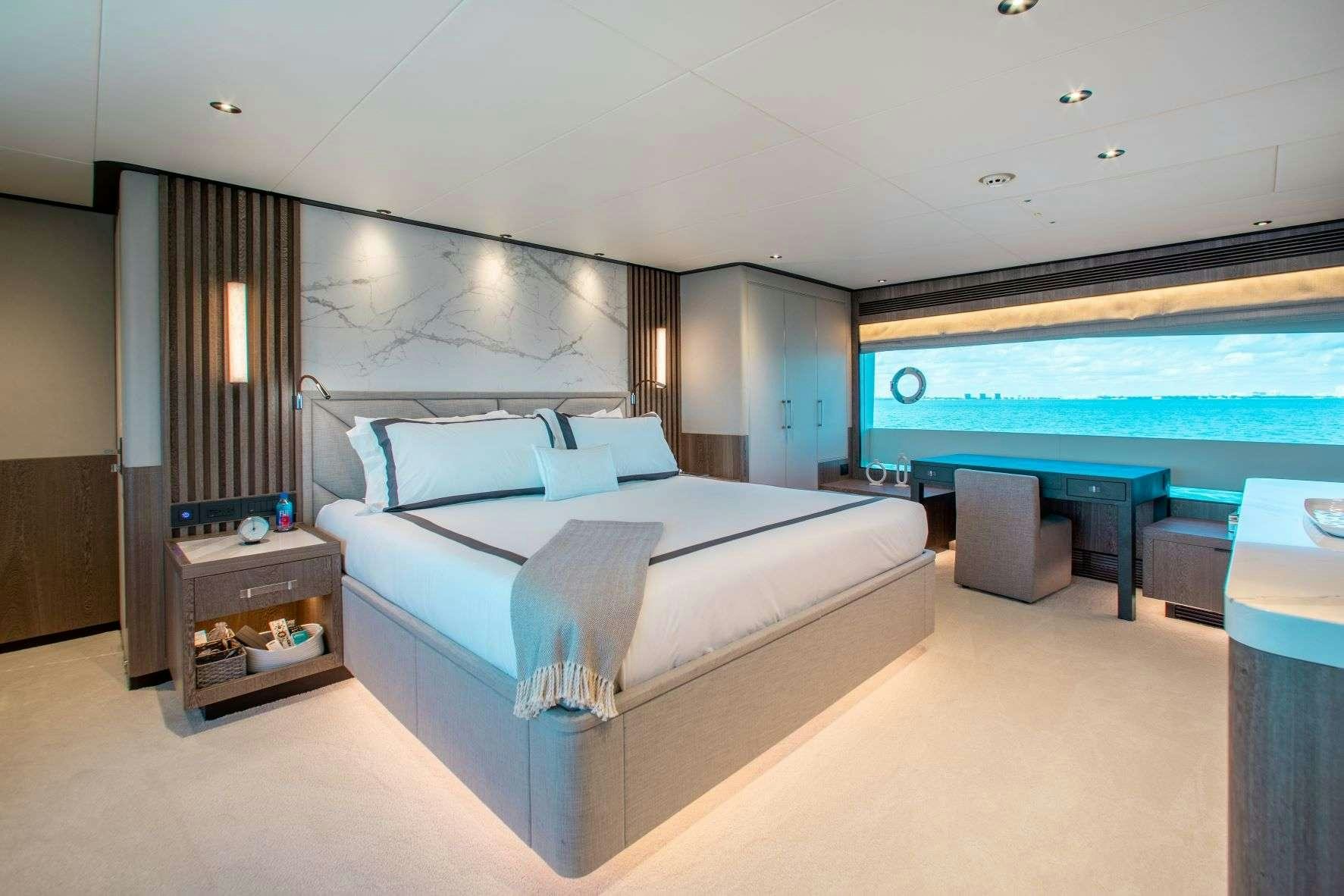 a large bedroom with a large bed aboard FREEDOM Yacht for Charter
