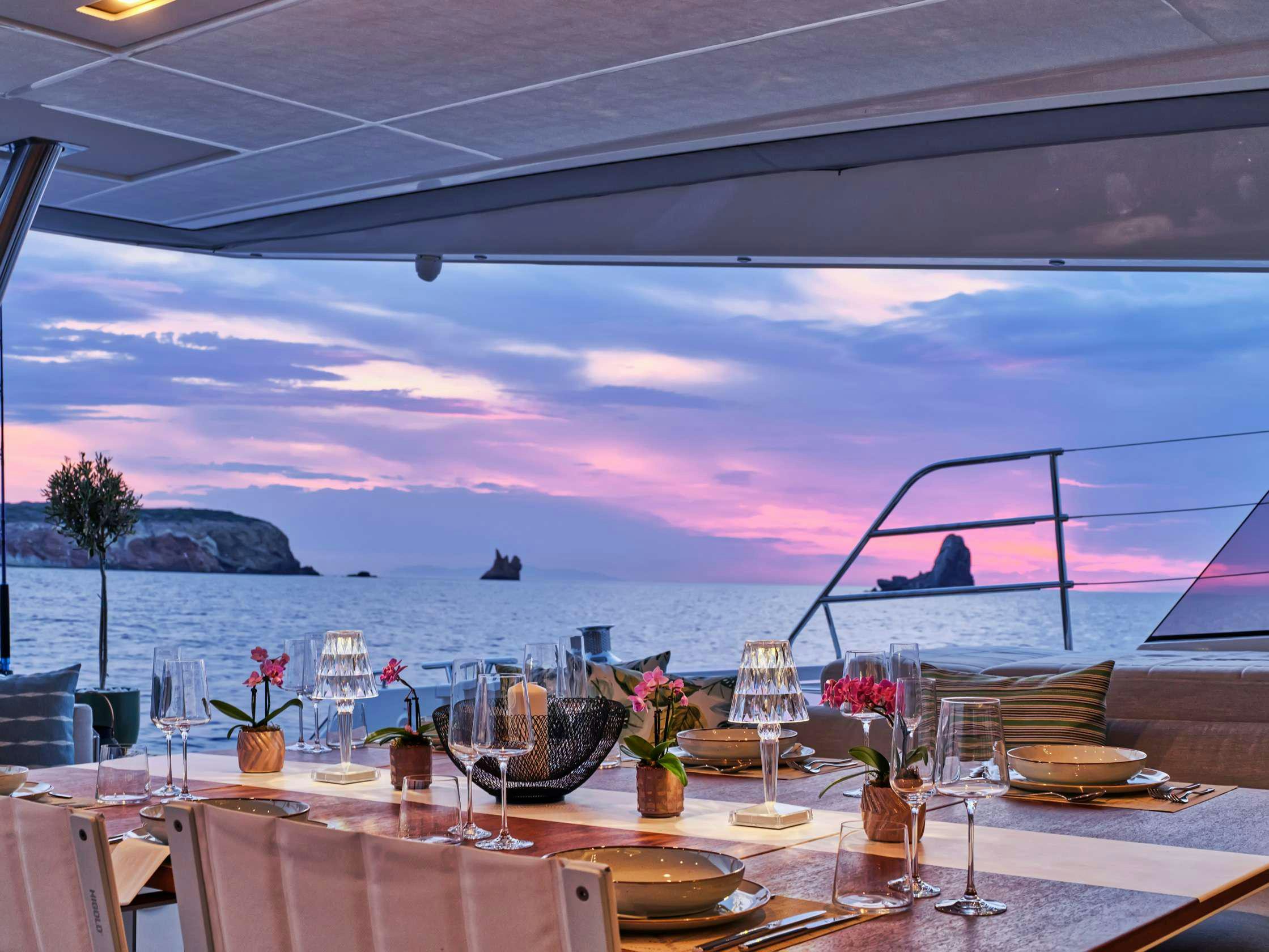 a table set for a dinner party aboard PIXIE Yacht for Charter