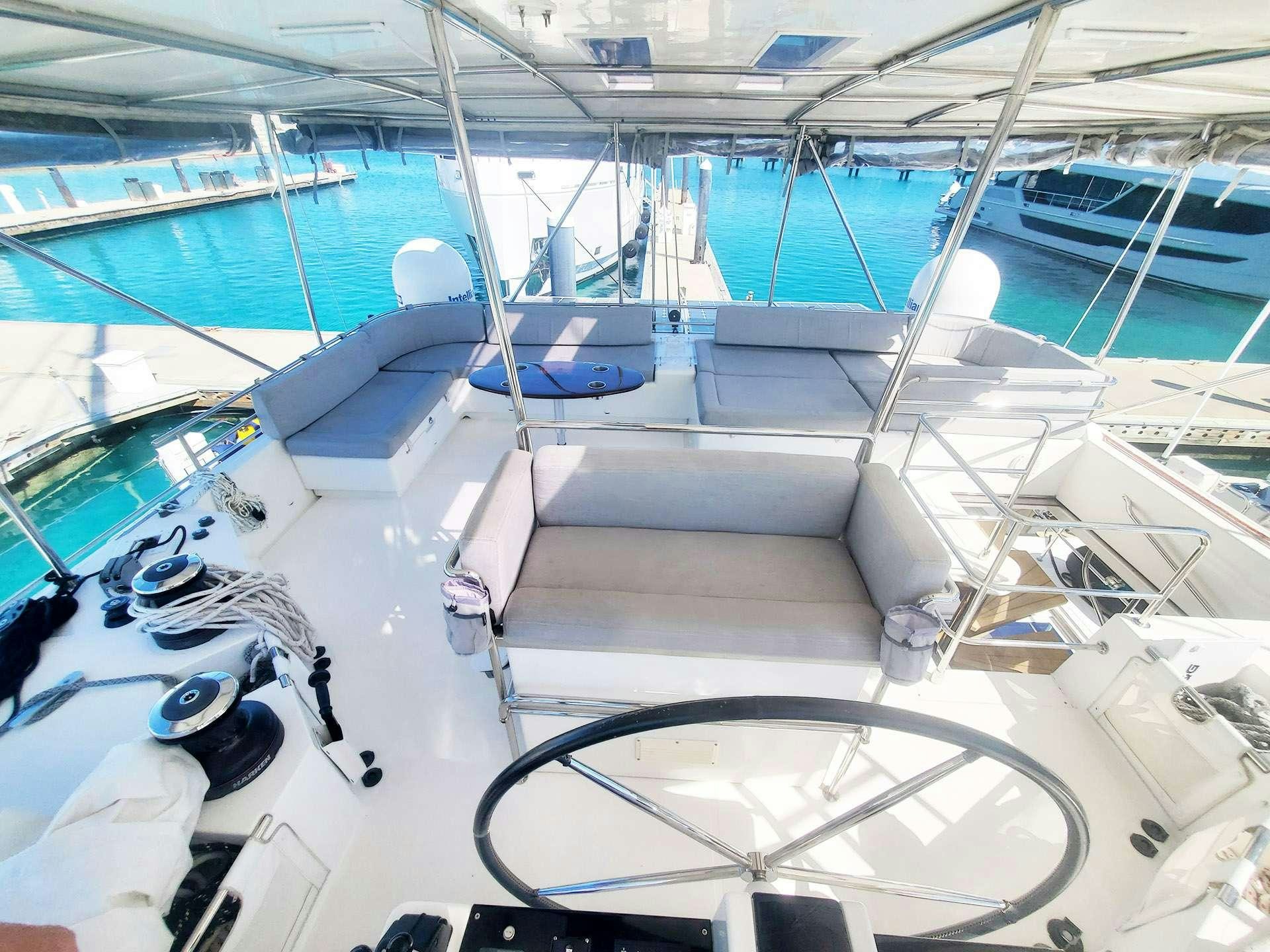 a large boat with a large amount of seats aboard BLUE CAT Yacht for Charter