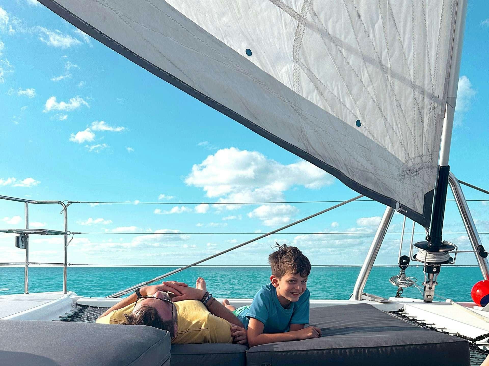 a man and a boy on a boat aboard BLUE CAT Yacht for Charter