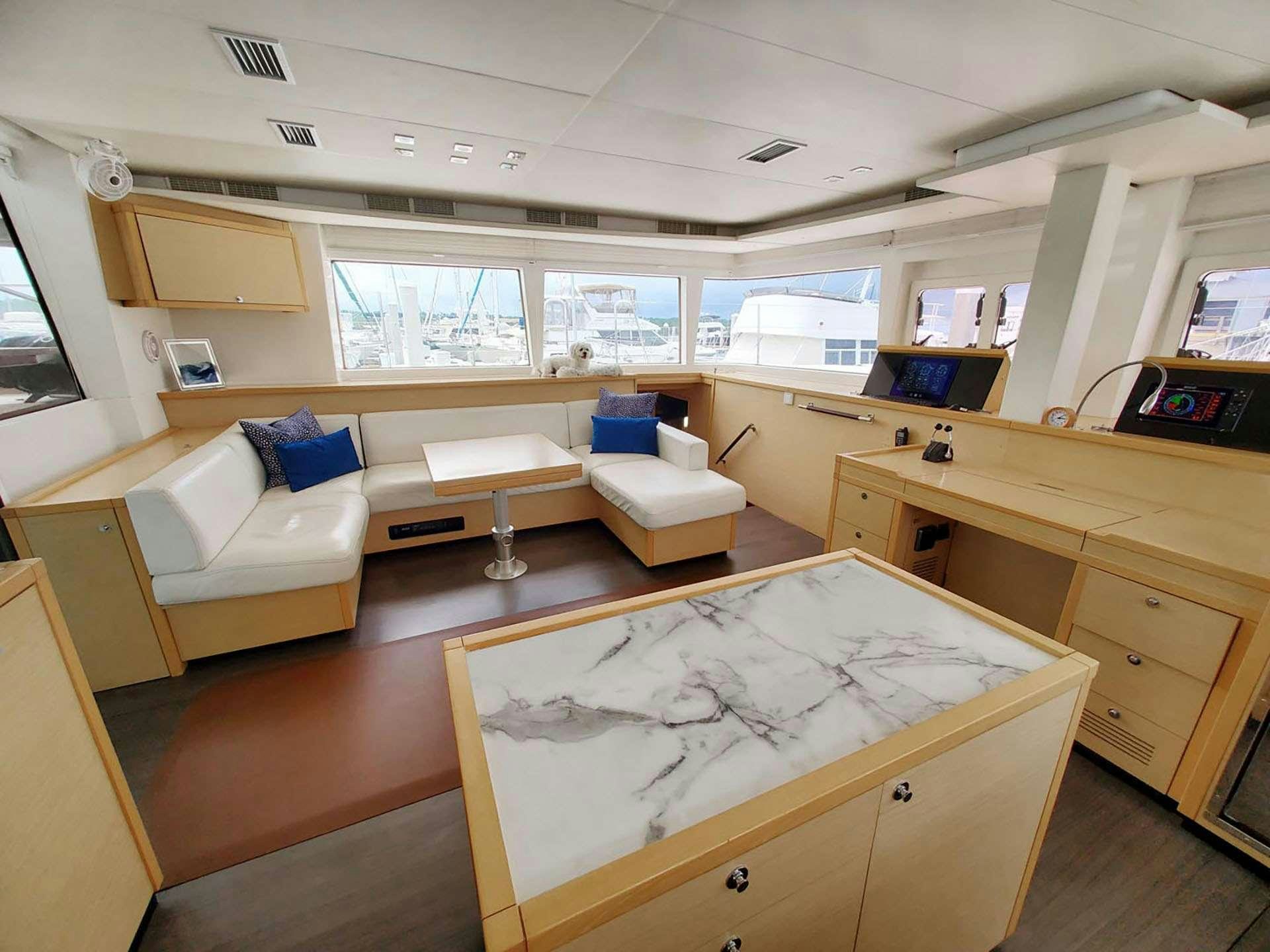 a room with a couch and a table aboard BLUE CAT Yacht for Charter