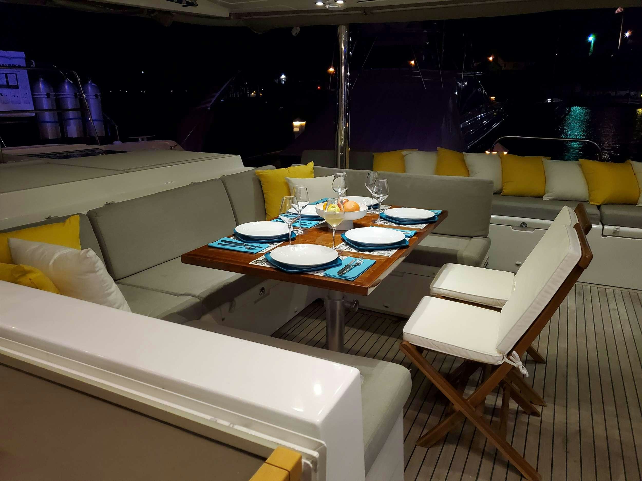 a room with a table and chairs aboard BLUE CAT Yacht for Charter