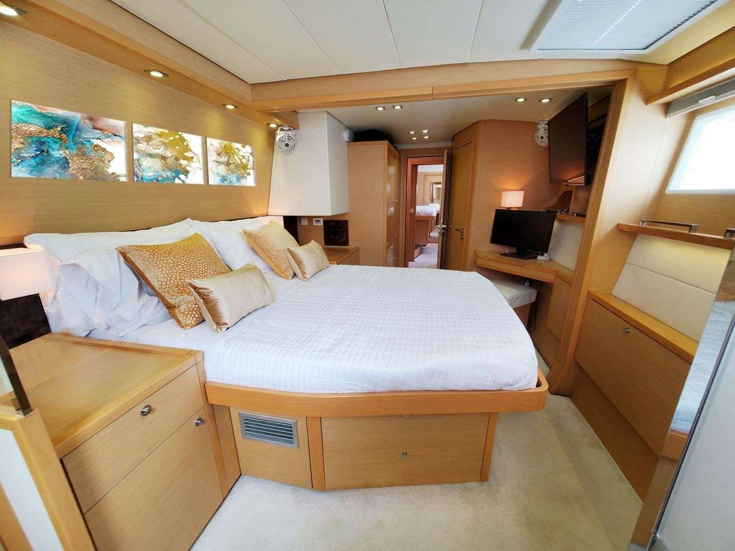 a bedroom with a bed aboard BLUE CAT Yacht for Charter