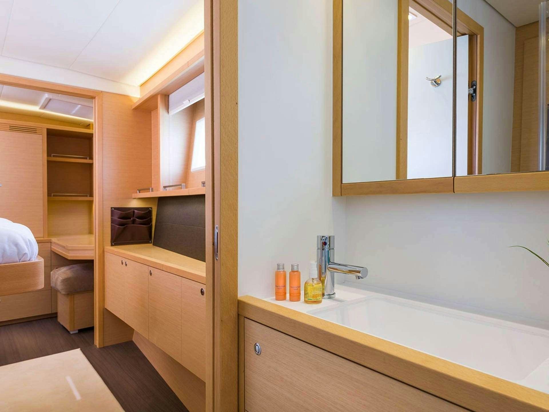 a bathroom with a sink and a mirror aboard BLUE CAT Yacht for Charter