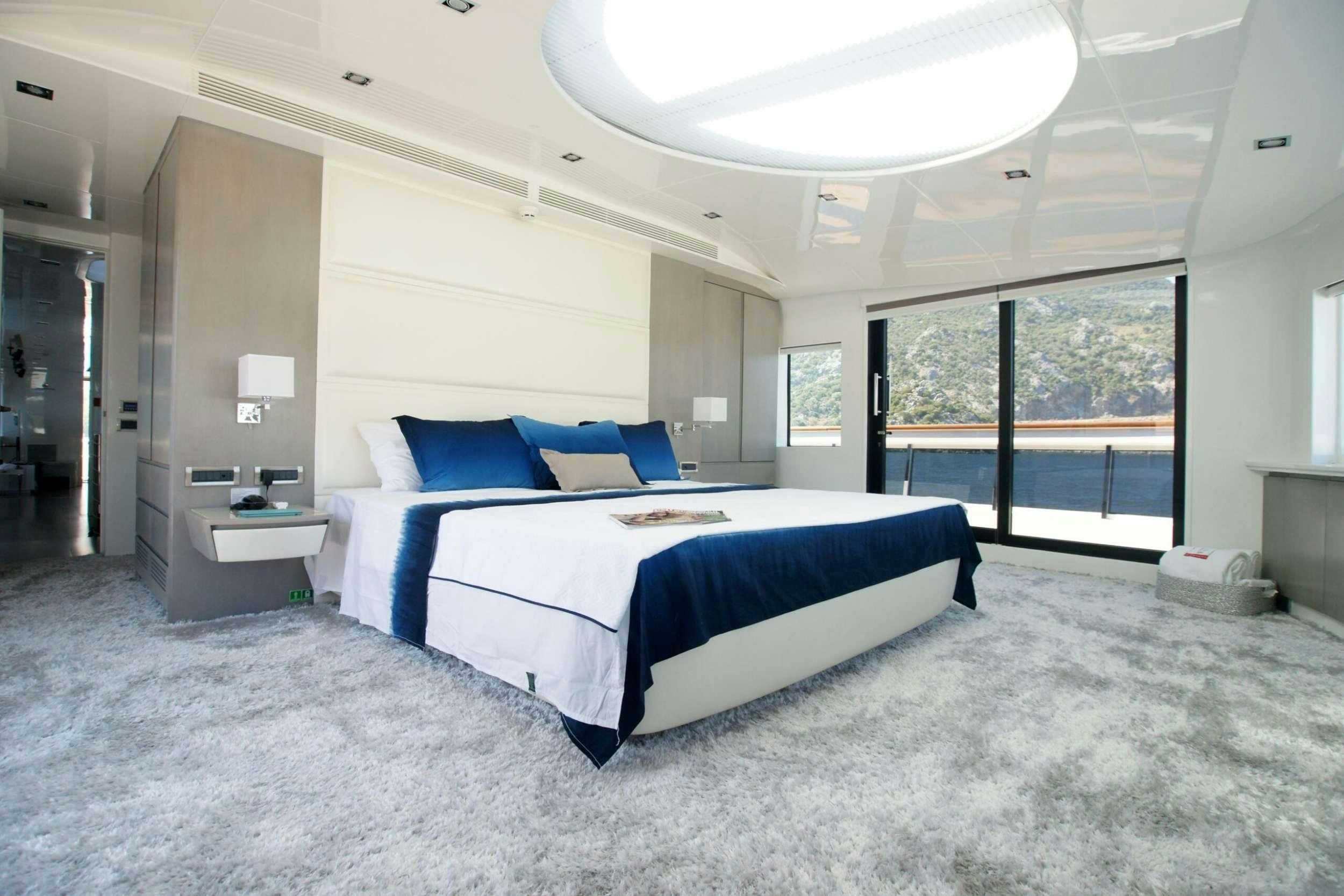 a large bedroom with a large bed aboard REM Yacht for Charter