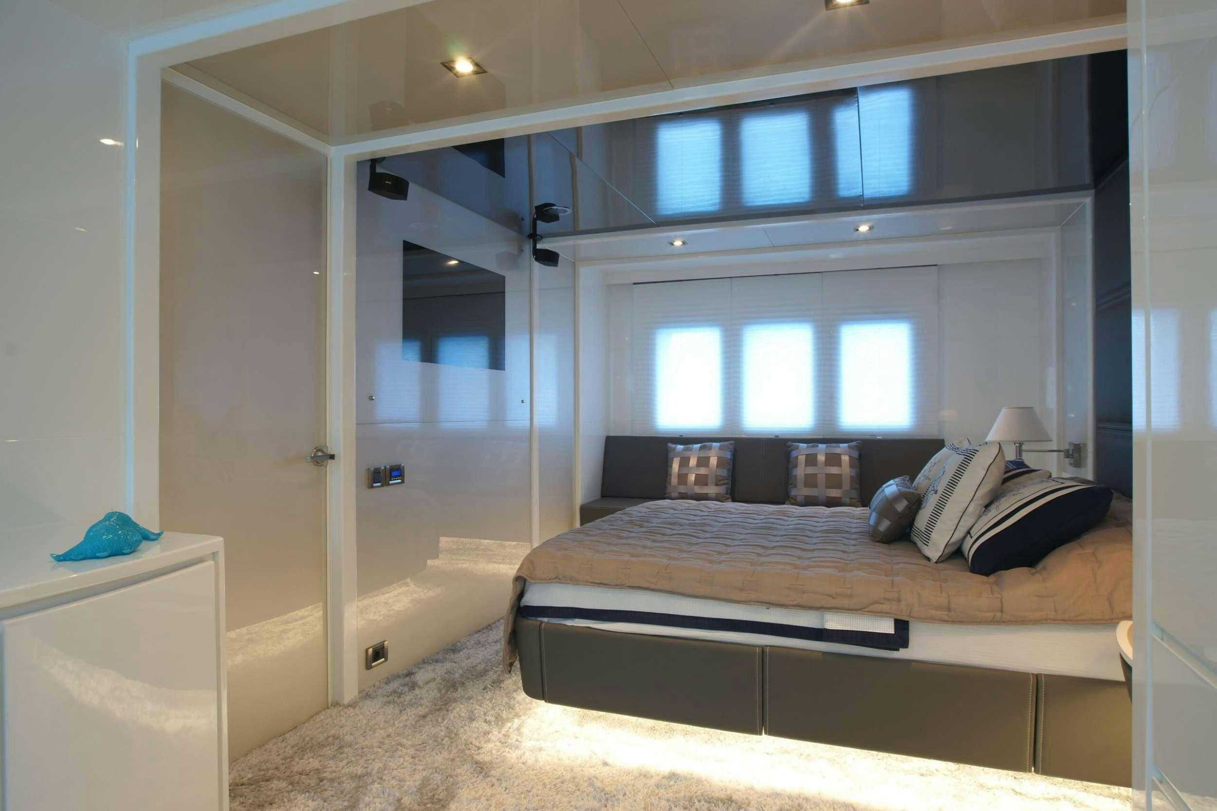 a bedroom with a bed aboard REM Yacht for Charter