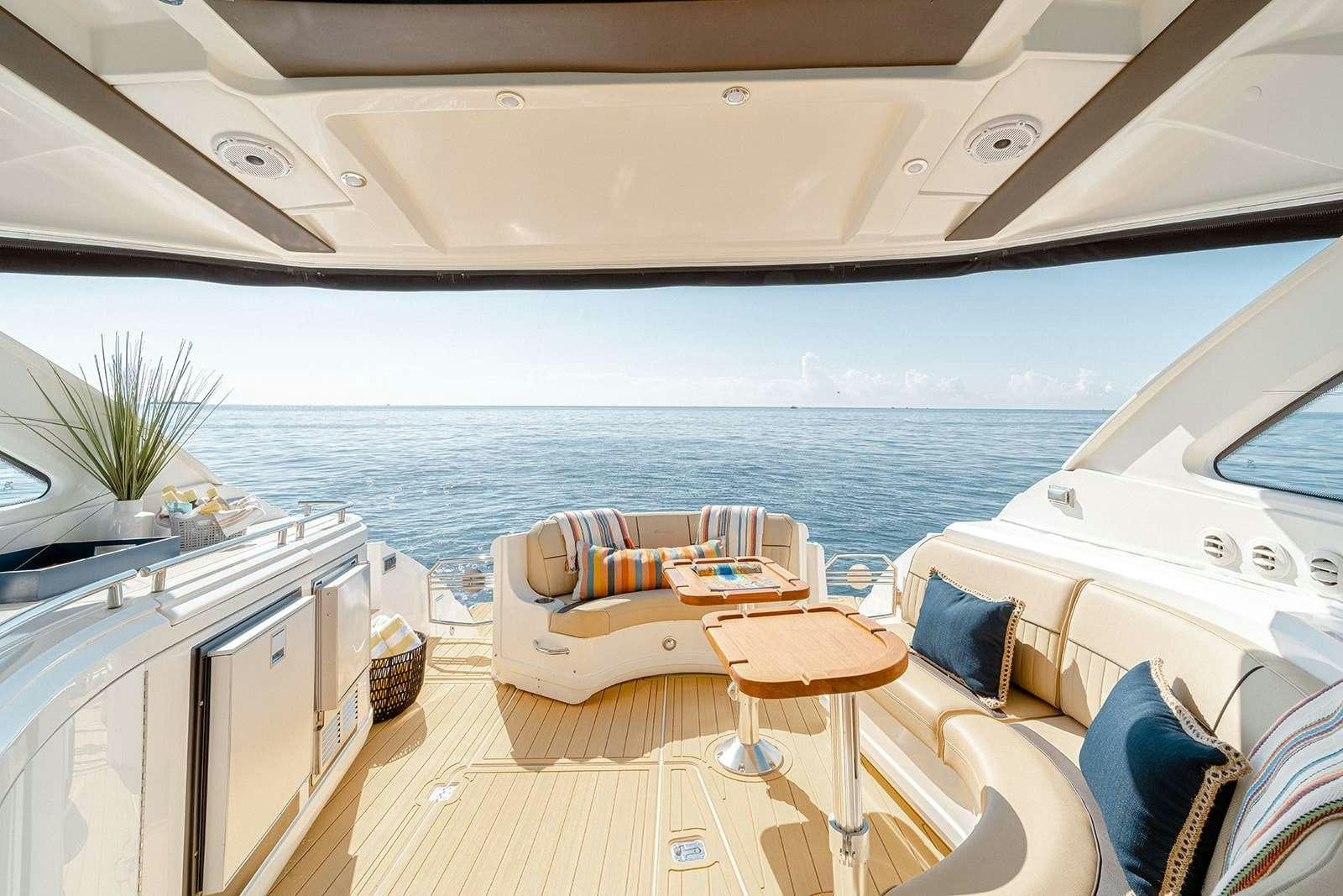 a boat with a table and chairs aboard EPIC Yacht for Charter