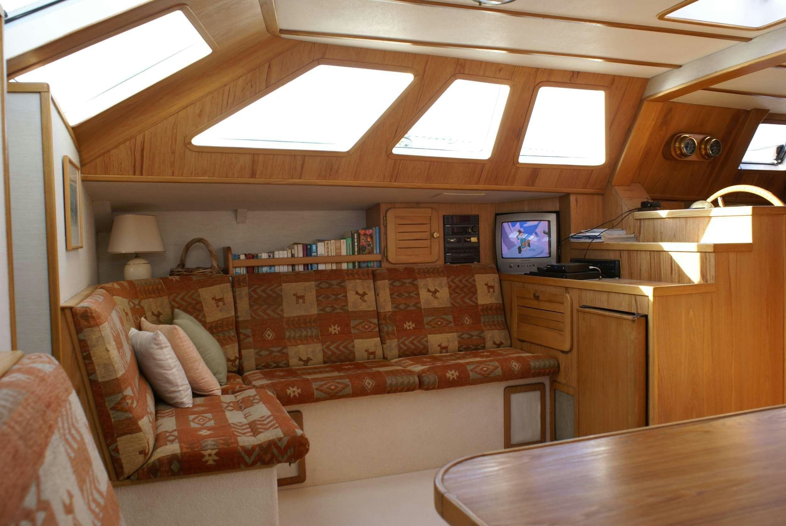 a living room with a couch and a tv aboard JAIPUR Yacht for Charter