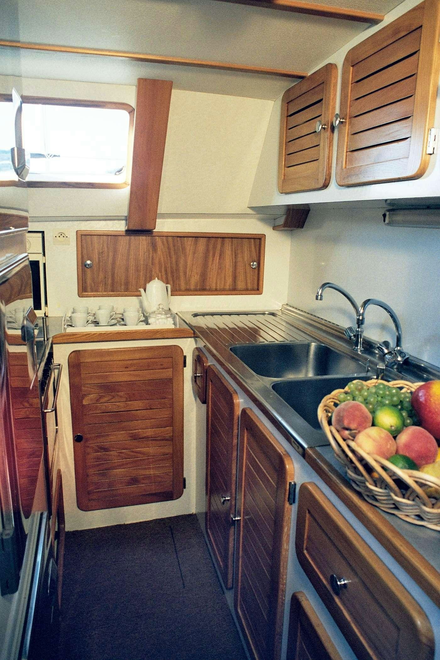 a kitchen with a sink and apples aboard JAIPUR Yacht for Charter