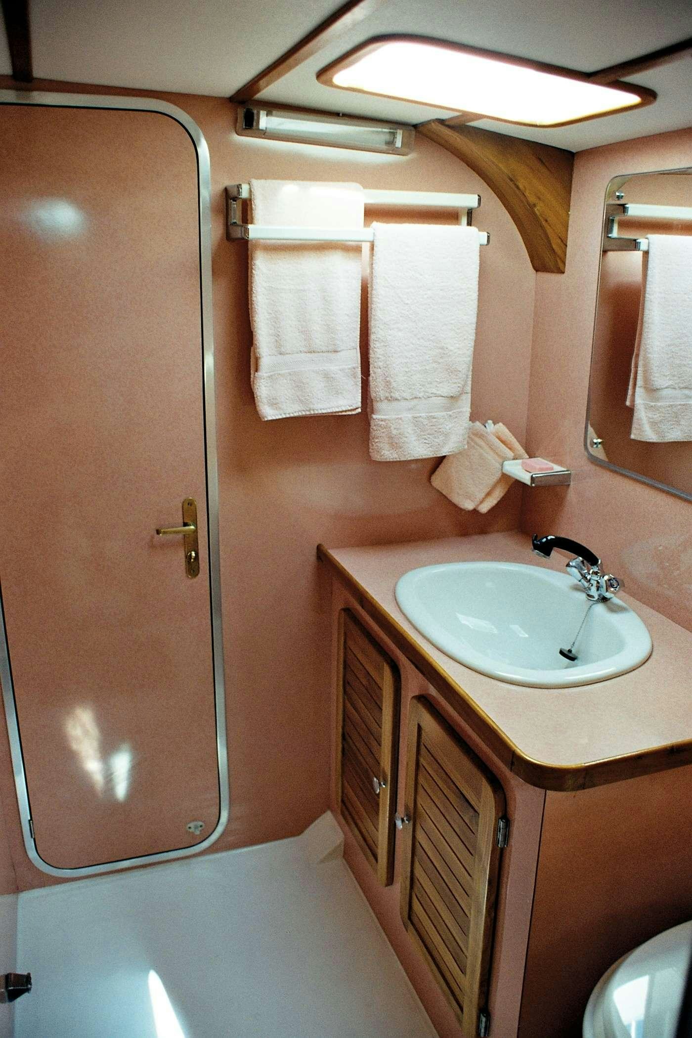 a bathroom with a sink and a shower aboard JAIPUR Yacht for Charter