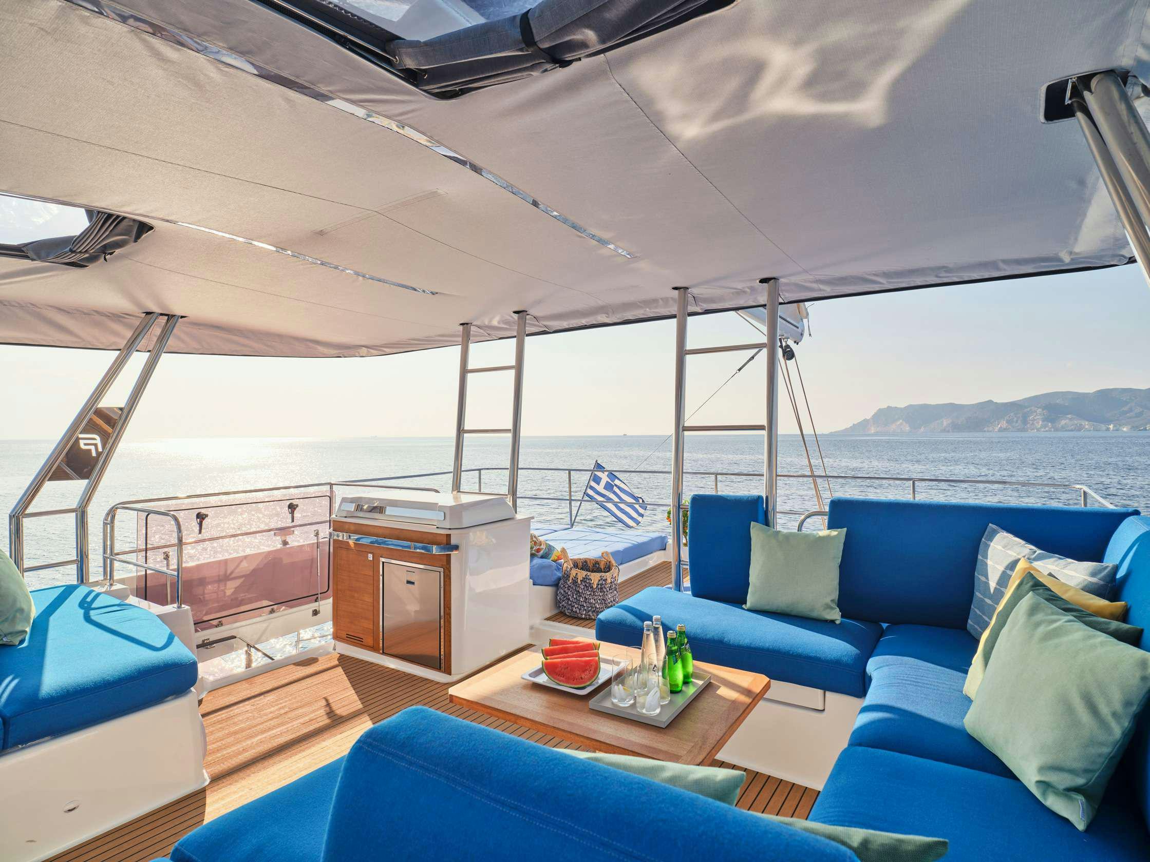 a boat with a table and a couch aboard APHAEA Yacht for Charter