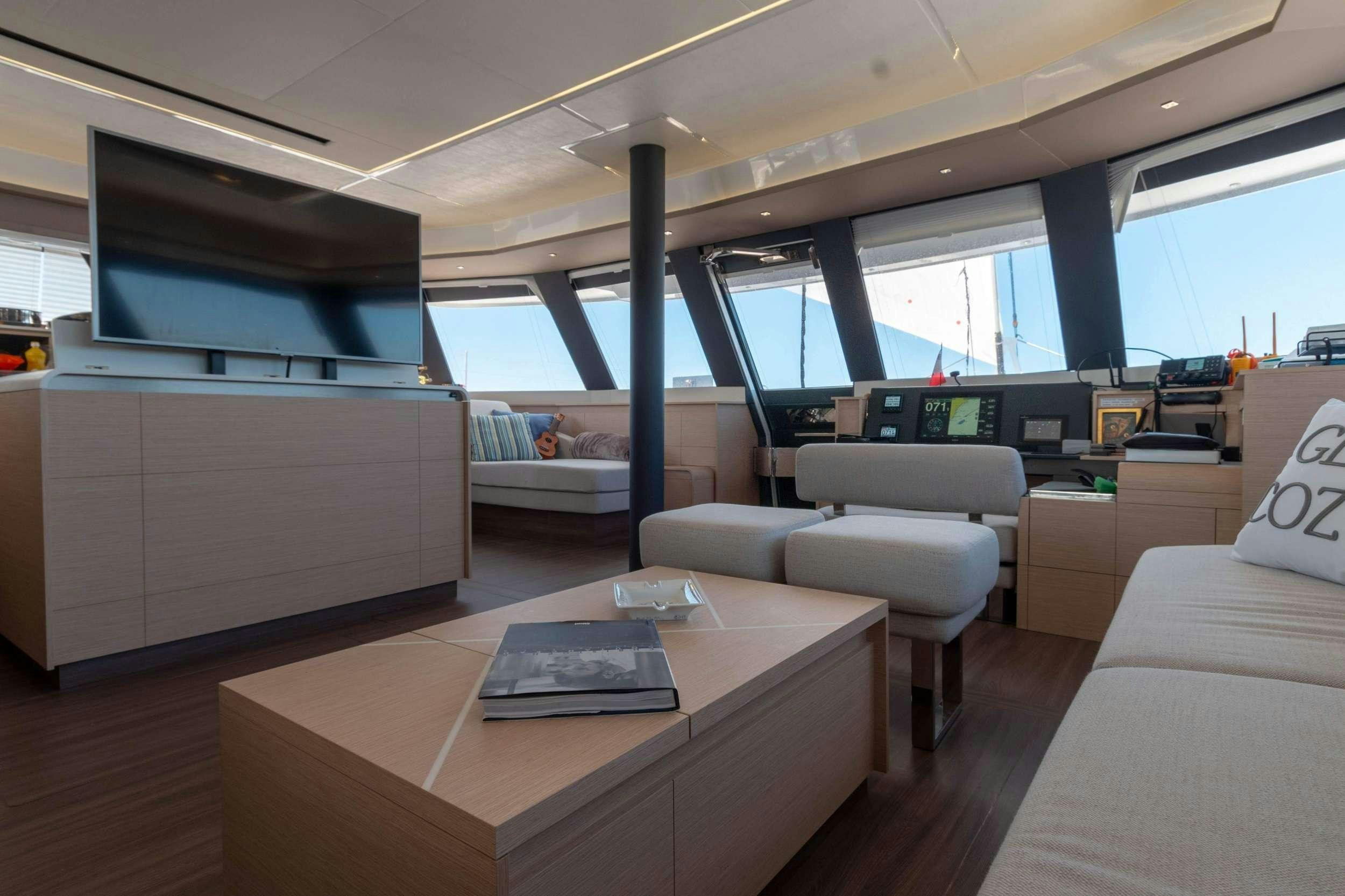 a room with a table and a couch aboard APHAEA Yacht for Charter