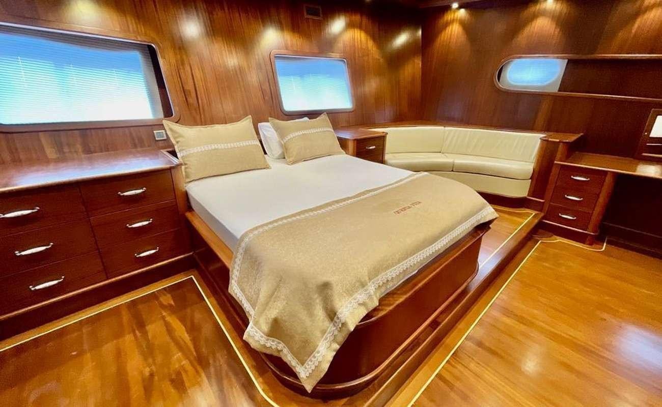 a room with two beds aboard QUESTA E VITA Yacht for Charter
