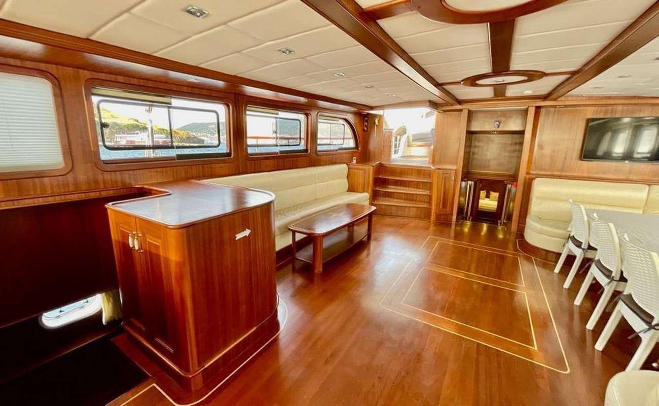 a room with wooden furniture aboard QUESTA E VITA Yacht for Charter