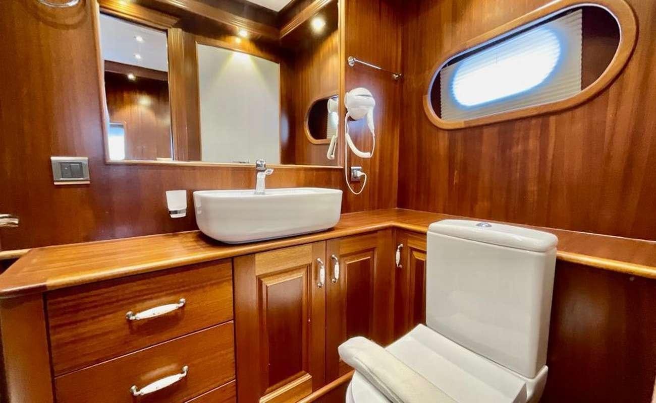 a bathroom with a sink and a mirror aboard QUESTA E VITA Yacht for Charter