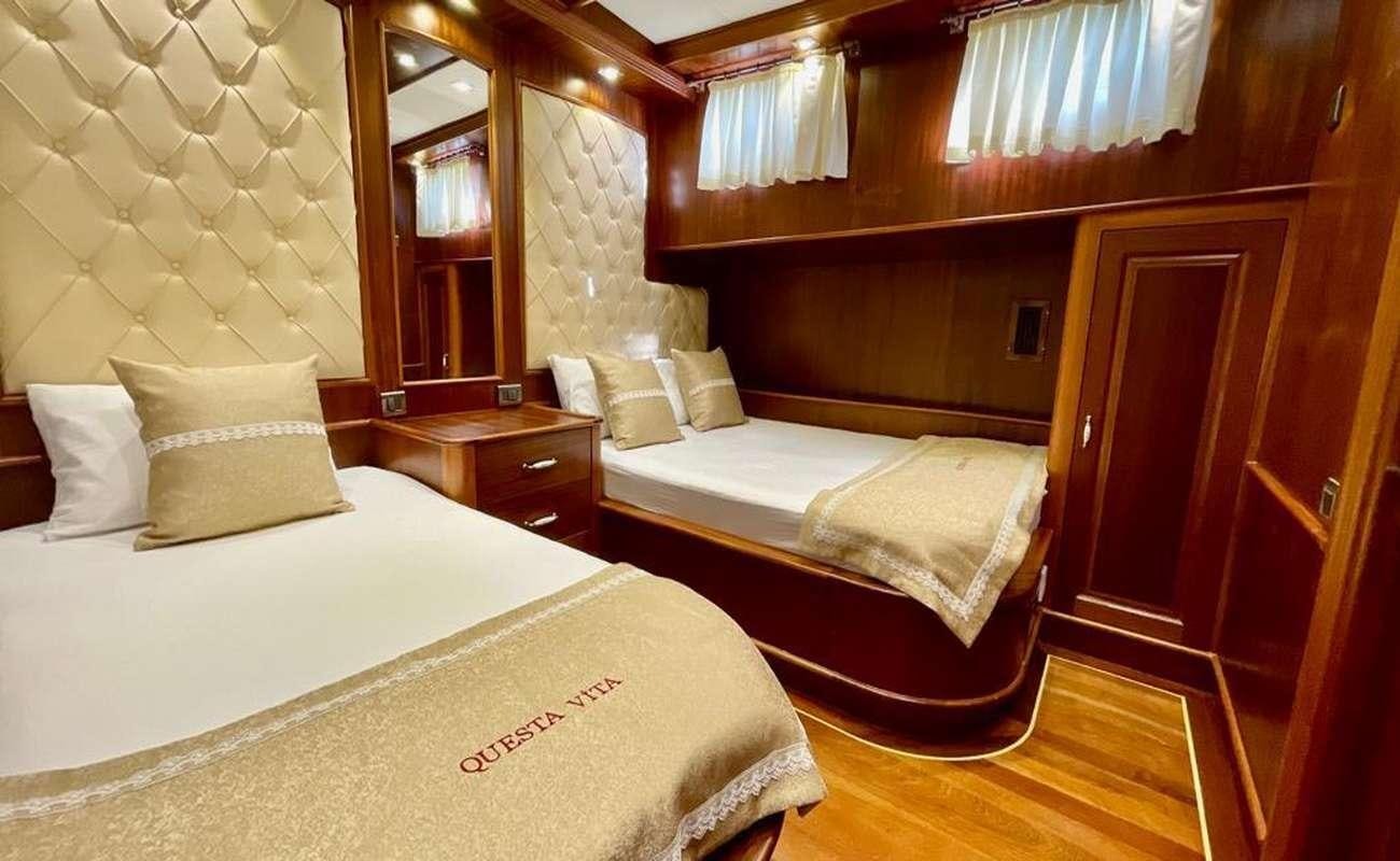 a couple of beds in a room aboard QUESTA E VITA Yacht for Charter