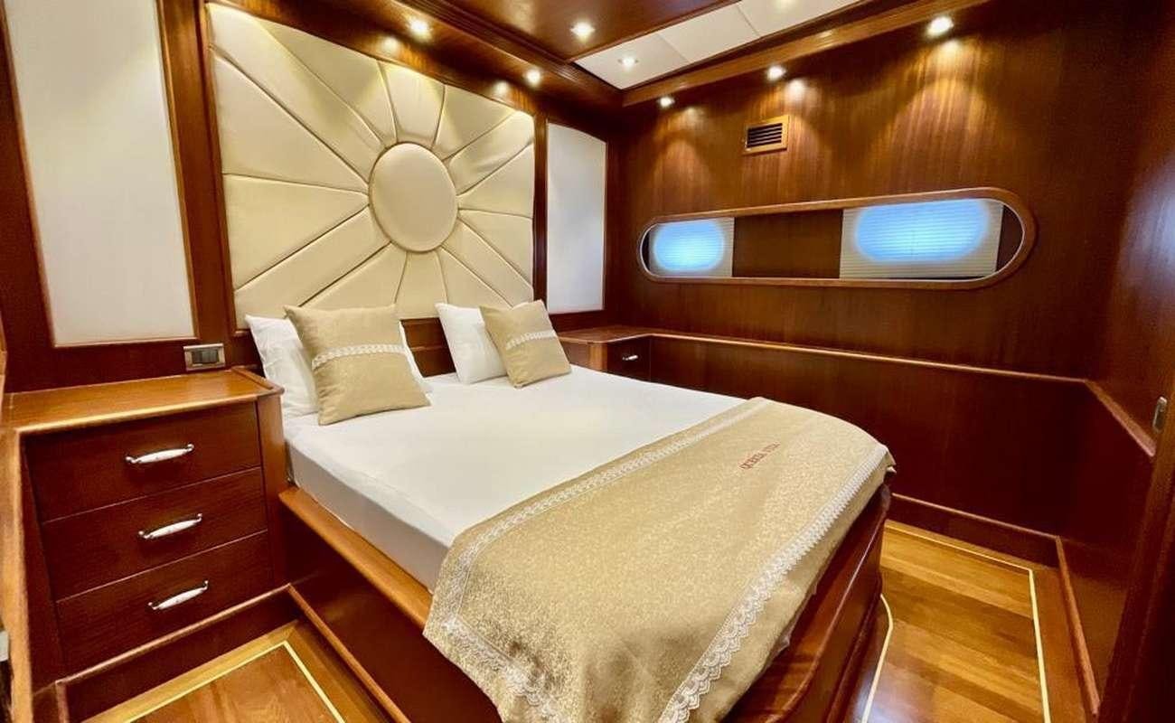 a room with two beds aboard QUESTA E VITA Yacht for Charter