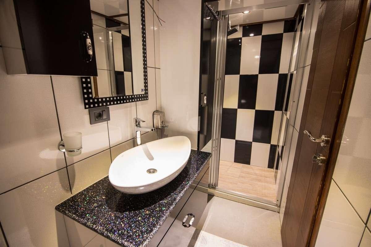 a bathroom with a sink and a mirror aboard NEVRA QUEEN Yacht for Charter