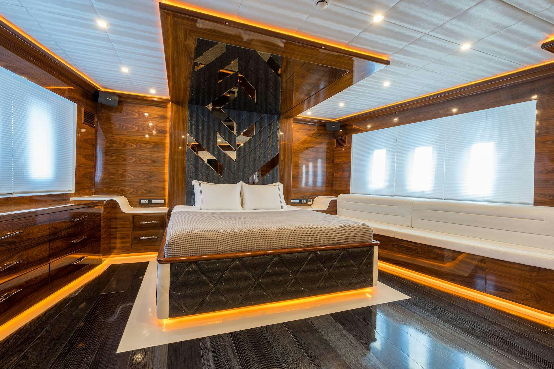 a room with a bed and a couch aboard LONG ISLAND Yacht for Charter