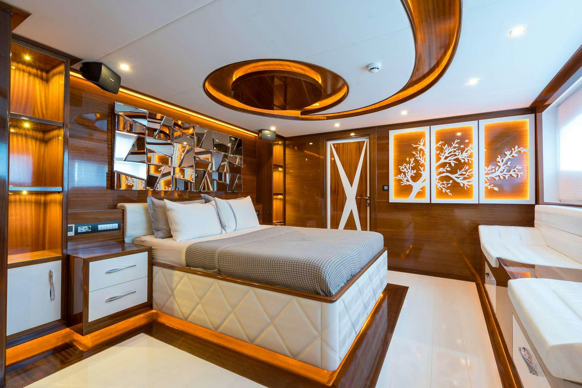 a room with a bed and a chandelier aboard LONG ISLAND Yacht for Charter