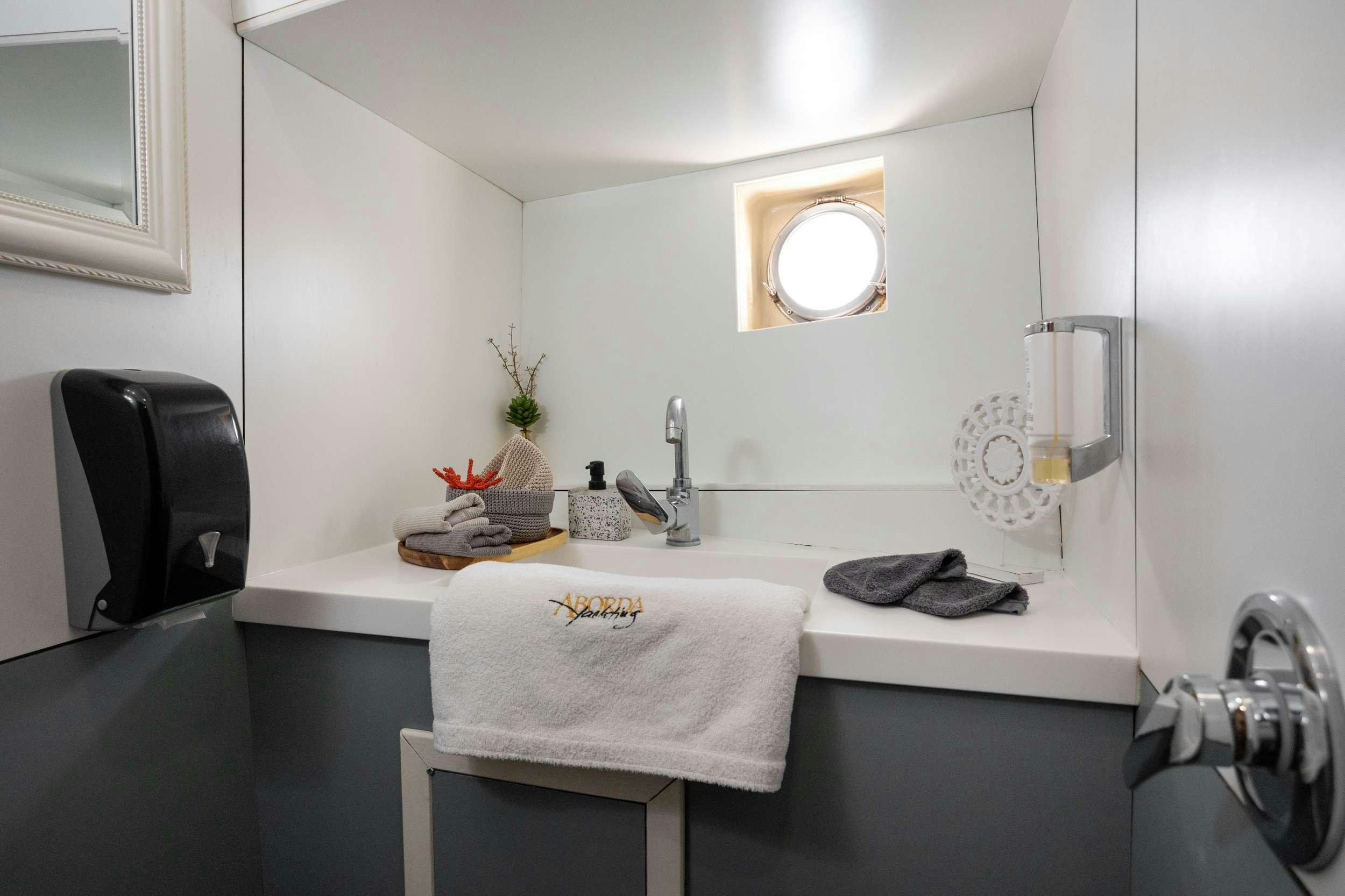 a bathroom with a sink and mirror aboard ABORDA Yacht for Charter