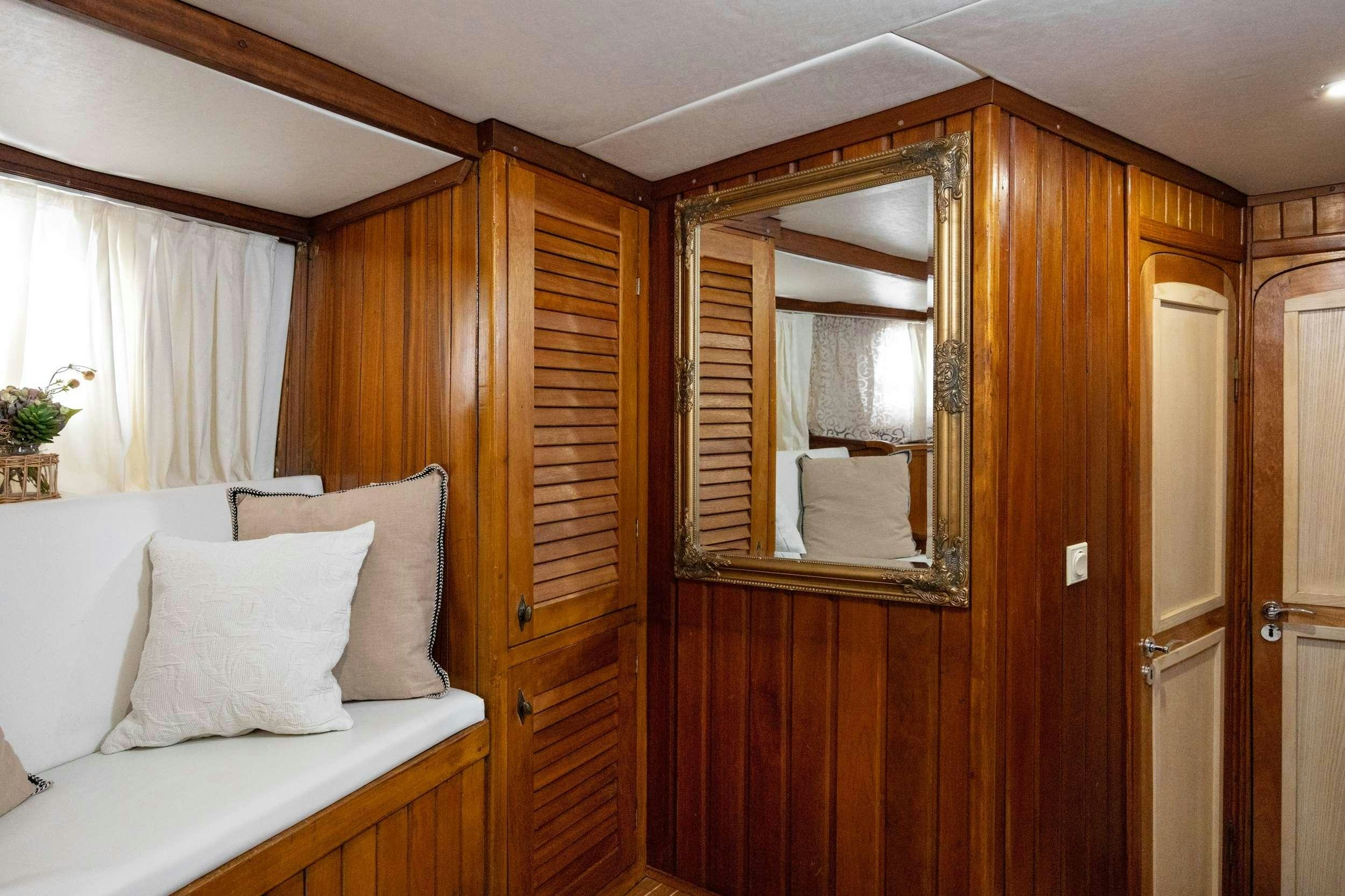 a bed and a mirror in a room aboard ABORDA Yacht for Charter