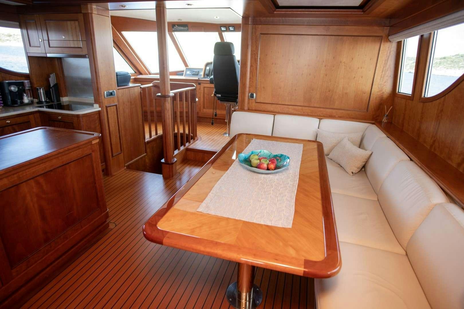 a kitchen with a table and a couch aboard SEA BREEZE II Yacht for Charter