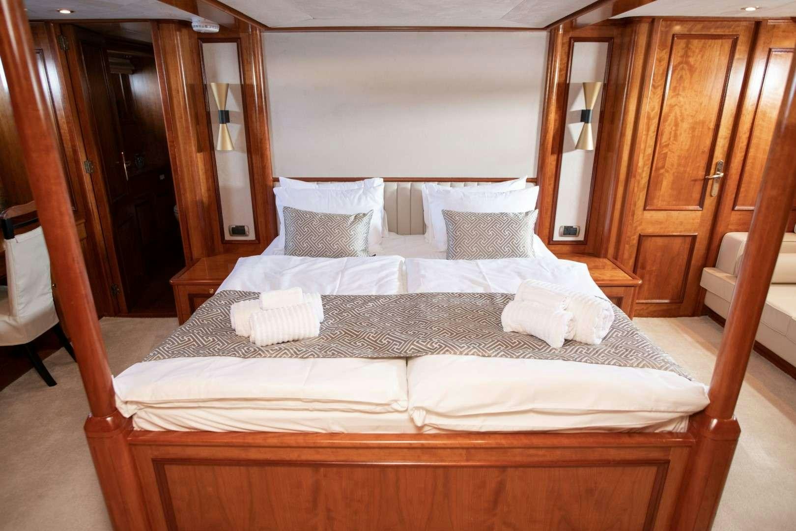 a bed with white sheets aboard SEA BREEZE II Yacht for Charter