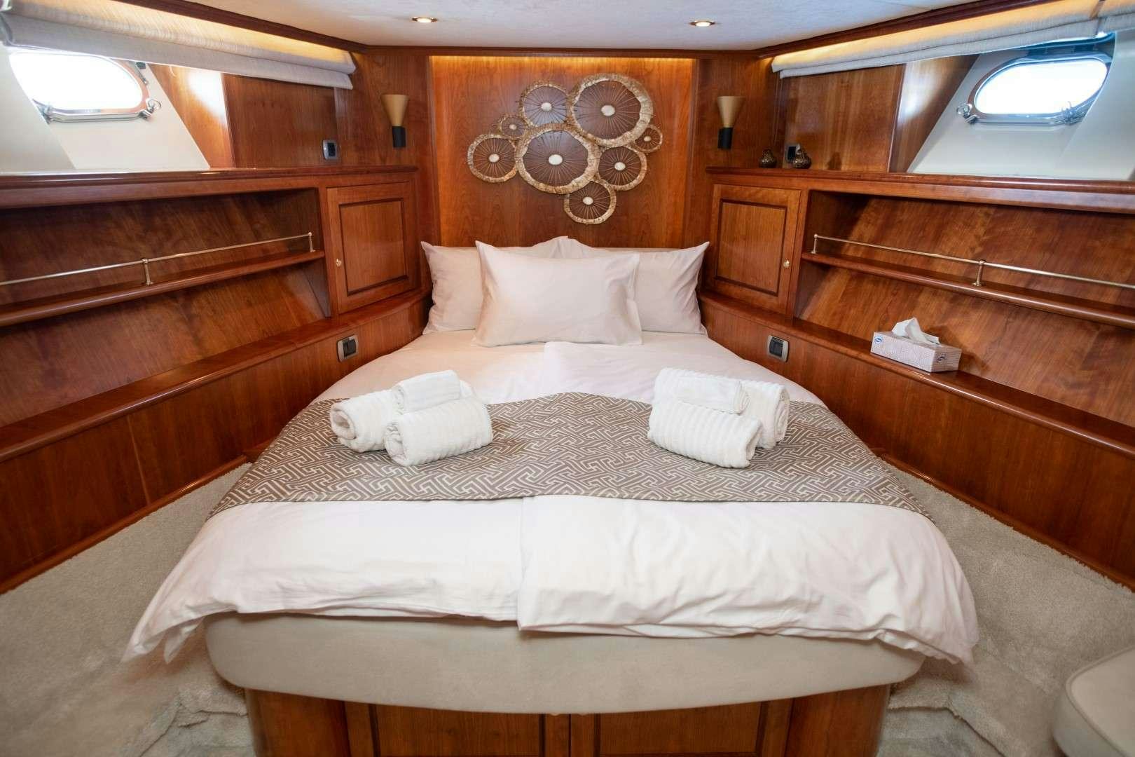 a room with a bed and a wood wall aboard SEA BREEZE II Yacht for Charter