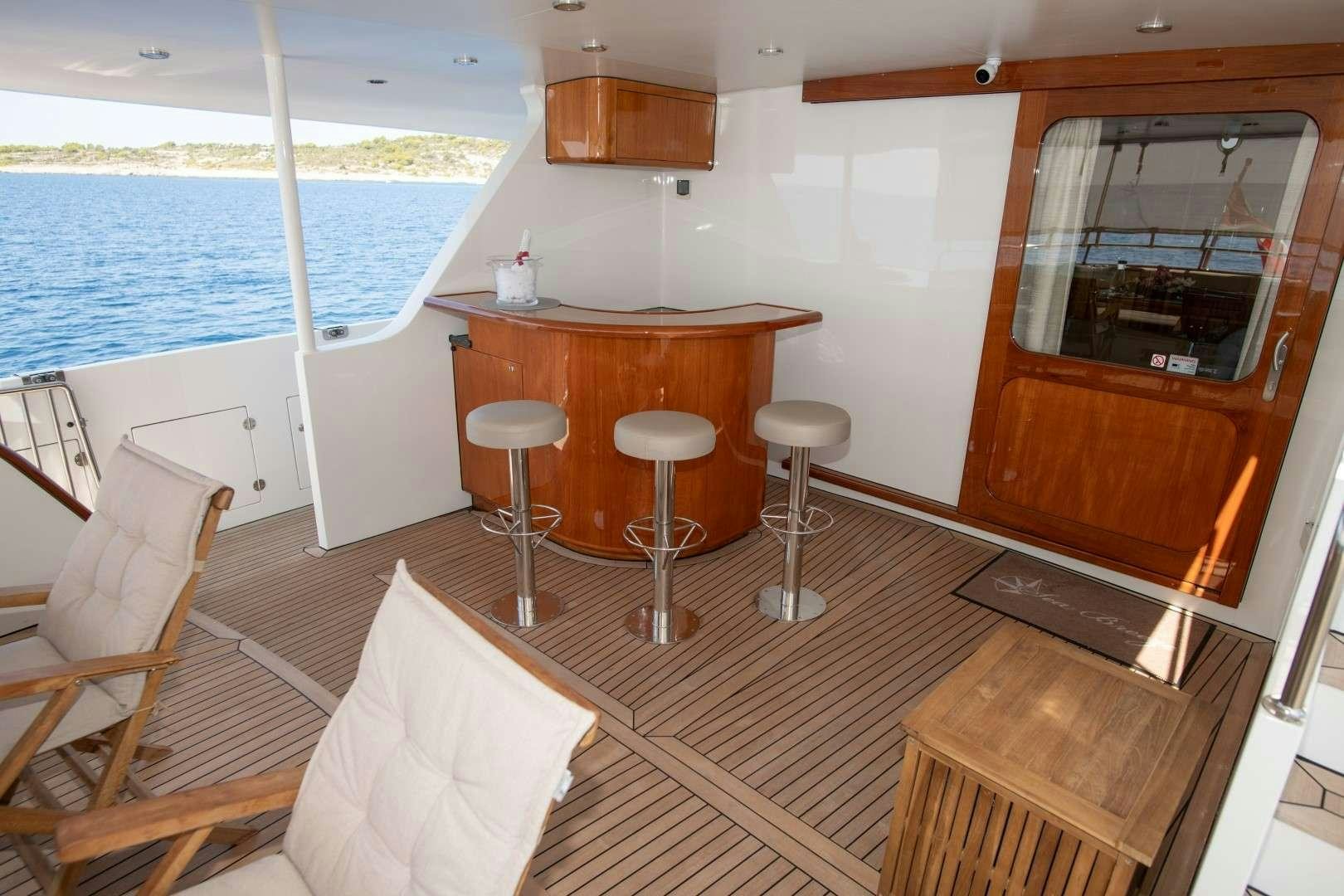 a boat with stools and tables aboard SEA BREEZE II Yacht for Charter