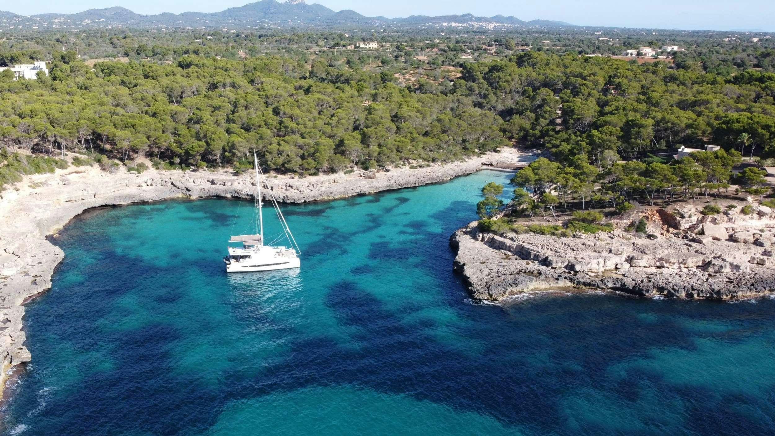 a boat sailing on a body of water aboard ANNA PINK Yacht for Charter