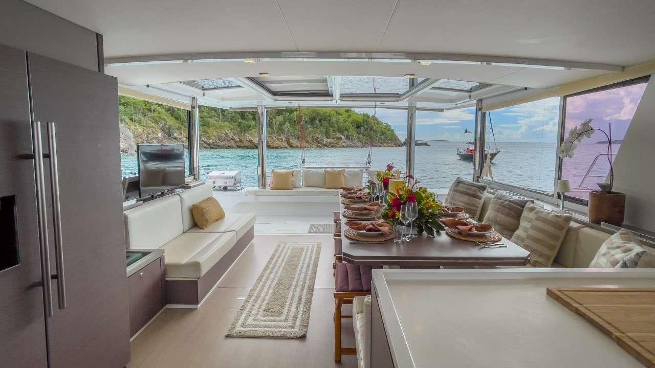 a kitchen with a table and chairs aboard ANNA PINK Yacht for Charter