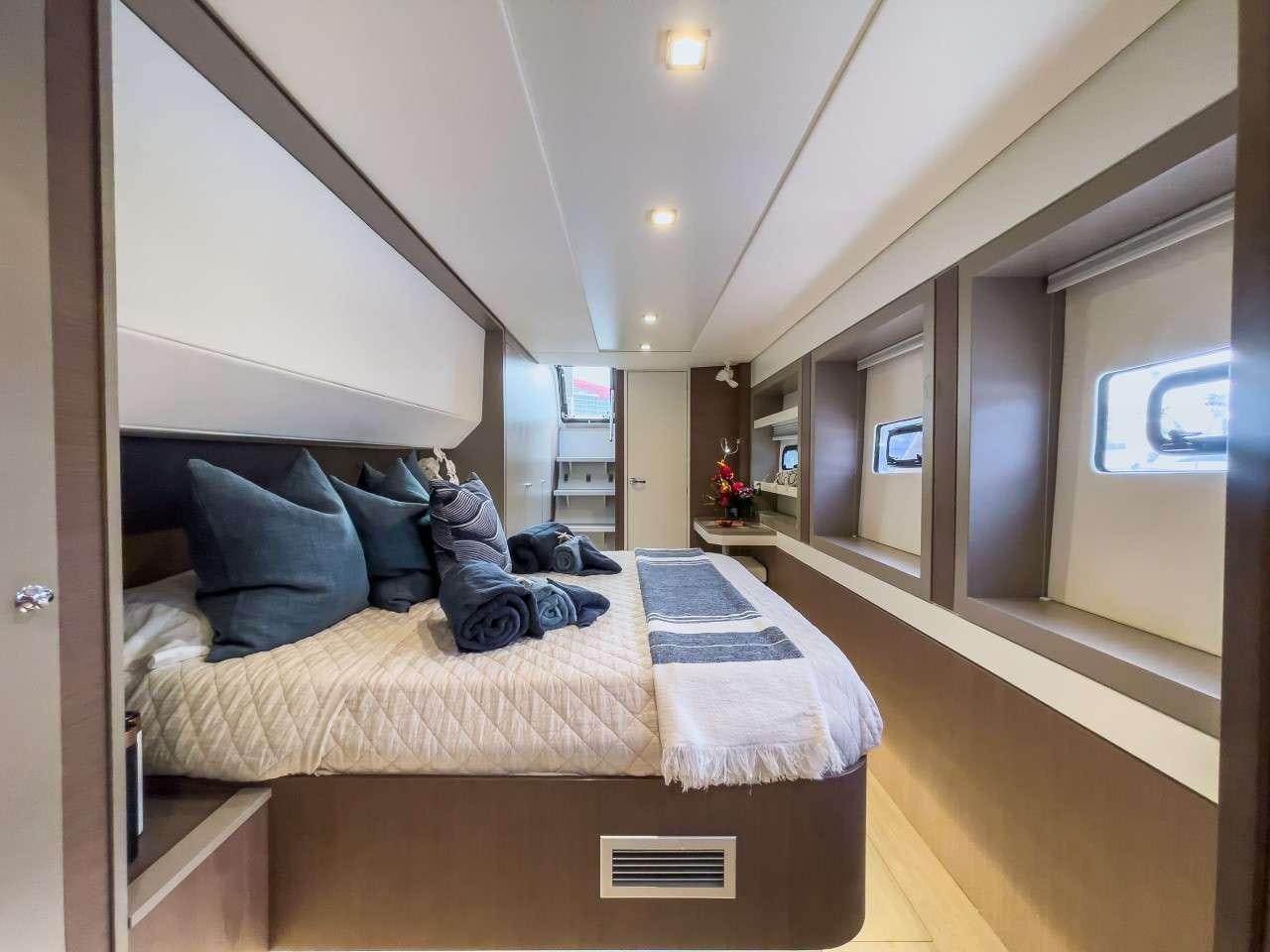 a room with a bed and a large mirror aboard ANNA PINK Yacht for Charter